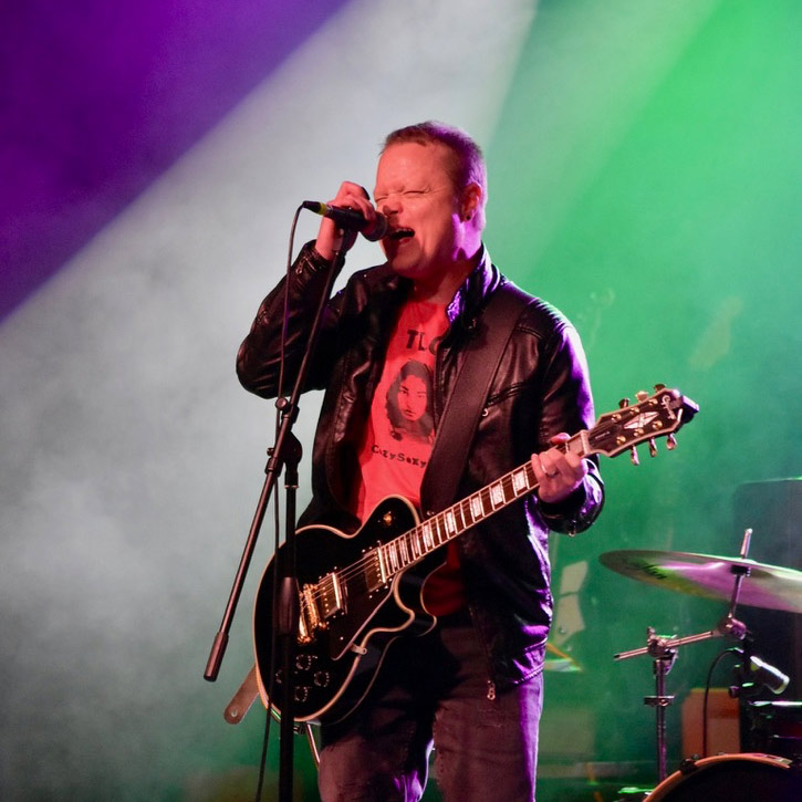 Chris Scheler singing with stage lights and fog